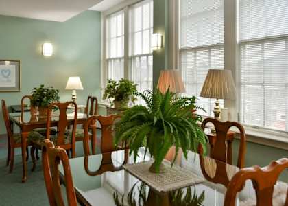a large dining room with a table and chairs