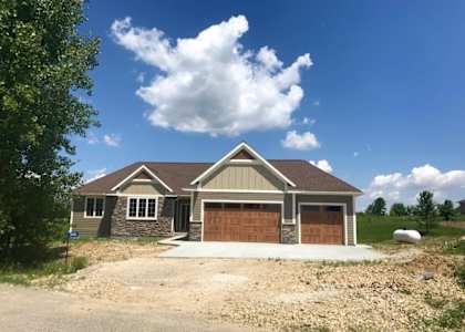 a house with a garage and a gravel driveway