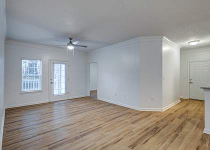 A room with wooden floors and a ceiling fan.