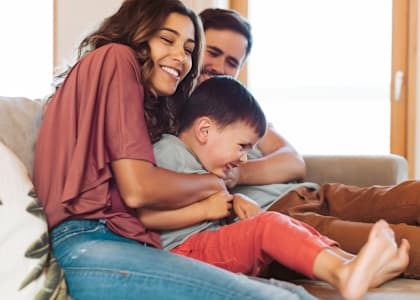 a woman sitting on a couch with a child on her lap