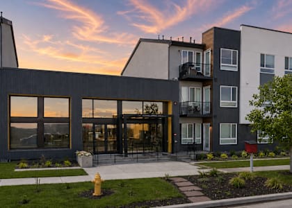 A modern apartment complex with a fire hydrant in front.