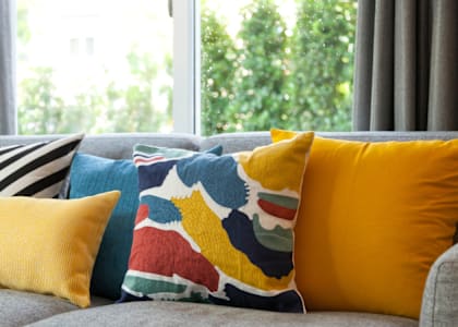 a group of pillows on a couch in front of a window