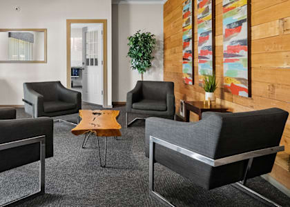 a living room with chairs and a coffee table