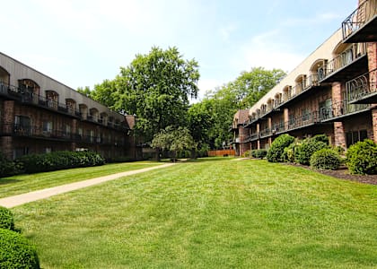 A grassy area in front of apartment buildings.