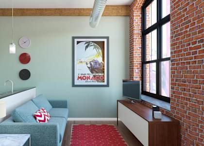A living room with a grey couch and a red carpet.
