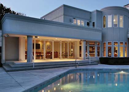 A modern house with a pool in the backyard.