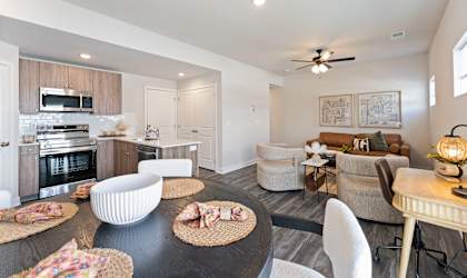 A modern kitchen with a dining area and a living room.