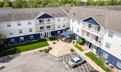 an aerial view of an apartment building with a car parked in front
