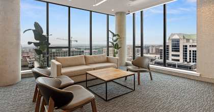 a living room with floor to ceiling windows and a view of the city