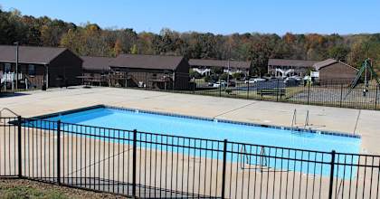 a swimming pool with a wrought iron fence around it