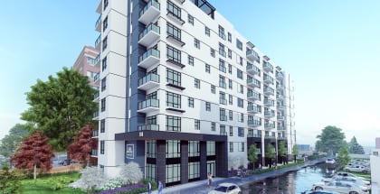 a rendering of a white and black apartment building next to a river