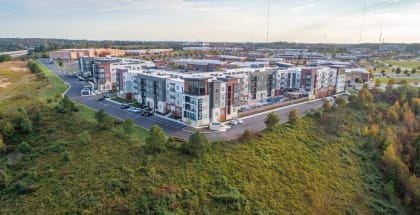 an aerial view of a row of apartment buildings on a grassy hill  at Vue at Westchester Commons, Midlothian, 23113