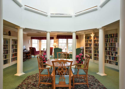 a dining room with a table and chairs in a library