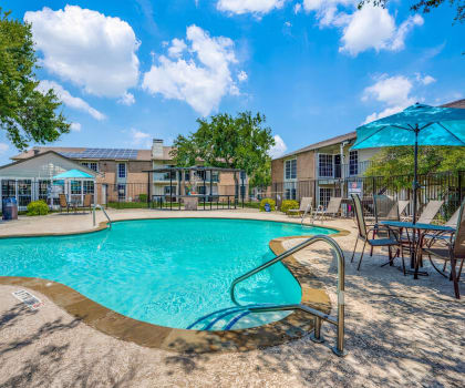 our apartments have a resort style pool with chairs and umbrellas  at Creek on Calloway, Richland Hills, 76118