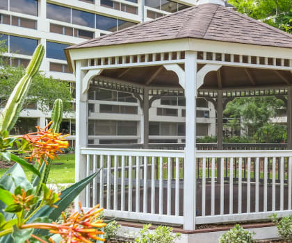Gazebo and tropical flowers in courtyard of Florida Christian apartments