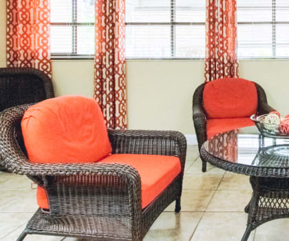 comfortable lobby sitting area with wicker chairs and couch with thick cushions
