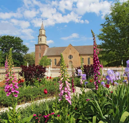 a church with a garden of flowers in front of it at The James On Merrimac, Virginia