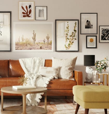 a living room with a brown couch and pictures on the wall