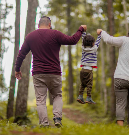 a family walking through the woods