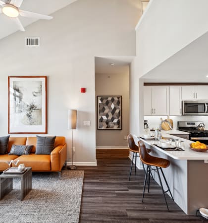 our apartments offer a living room with a couch a coffee table and a kitchen with a breakfast