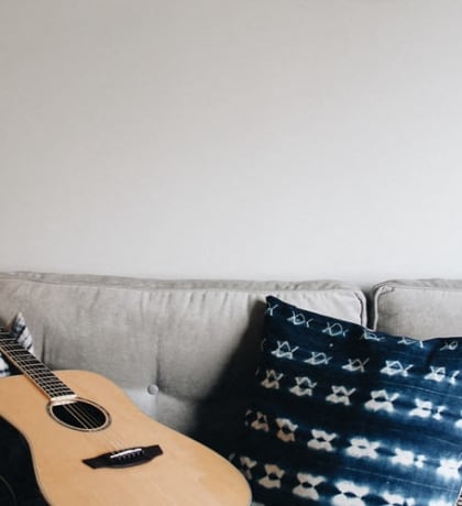 Stock photo of guitar on sofa