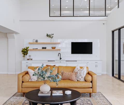 a living room with white walls and a yellow couch