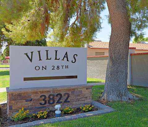 a home with a sign that says villas on 28th