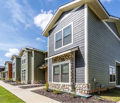 a row of townhomes with a blue sky in the background