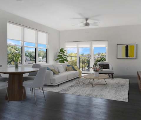 a living room with a white couch and a dining room table