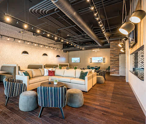 a seating area with couches tables and chairs