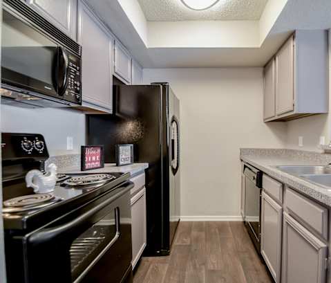 Efficient Appliances In Kitchen at Trinity Village Apartments, Dallas, TX, 75287