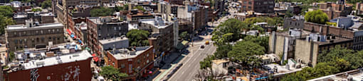 A city street with a crosswalk and traffic.
