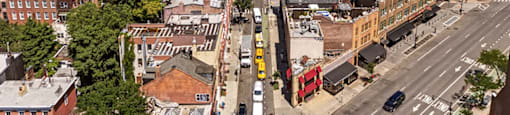A city street with cars and buildings.