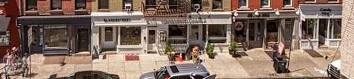 A street view of a city with buildings and cars.