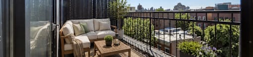 A balcony with a table and chairs is shown.