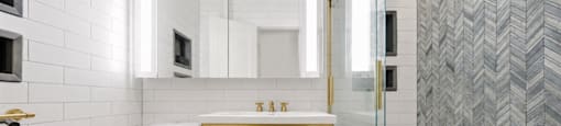 A white toilet sits next to a sink in a bathroom.