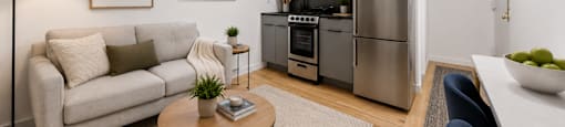 A modern kitchen with a refrigerator, oven, and microwave.