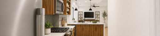 A modern kitchen with wooden cabinets and stainless steel appliances.