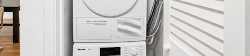 A washing machine is sitting in a cabinet.