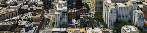 A cityscape with a mix of residential and commercial buildings.