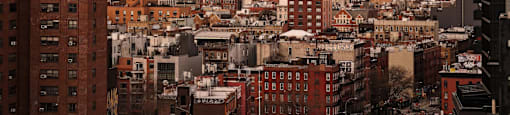 A cityscape with a mix of modern and older buildings.