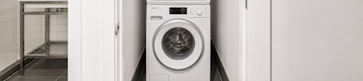 A white washing machine in a laundry room.