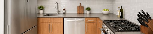A modern kitchen with wooden cabinets and stainless steel appliances.