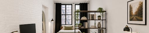 A white room with a desk, chair, and bed.