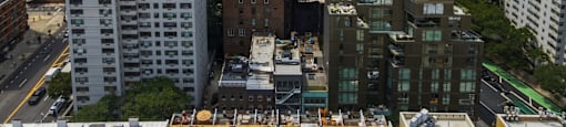 A cityscape with a mix of modern and older buildings.