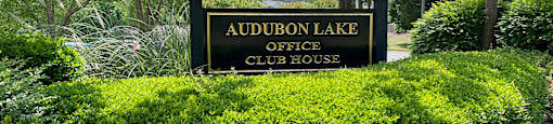 a sign for the audubon lake office club house