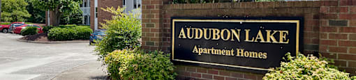 a sign that says audubon lake apartment homes