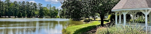 a gazebo on the shore of a lake