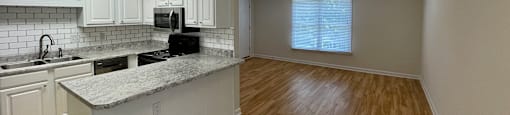 a view of the kitchen and living room from the dining room