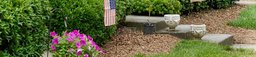 a house with two flags in the front yard